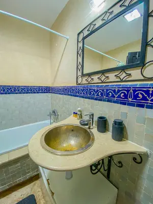 a bathroom with a sink and a mirror at Hamza immobiler in Marrakech