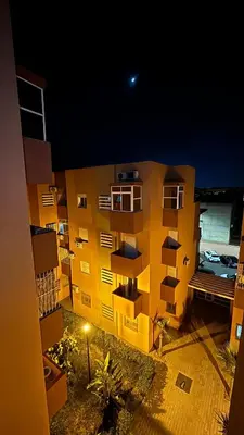 a view of a apartment building at night at Marrakech menara in Marrakech