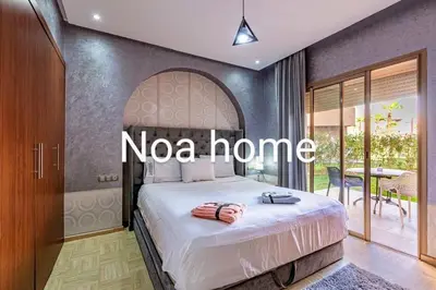a bedroom with a bed with a nova home sign on it at Marrakech prestigia rez-de-jardin avec accès direct piscine golf in Marrakech