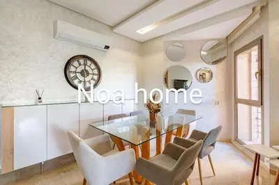 a dining room with a glass table and chairs at Marrakech prestigia rez-de-jardin avec accès direct piscine golf in Marrakech