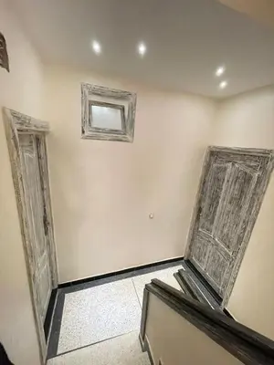 an empty room with two doors and a window at Appartement Neuf et Moderne in Marrakech