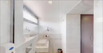 a white bathroom with a sink and a mirror at Très Beau Duplexe avec piscine depuis la terrasse in Marrakech