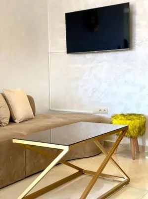 a living room with a couch and a glass table at Stylish Apartment IN Marrakech E25 in Marrakech