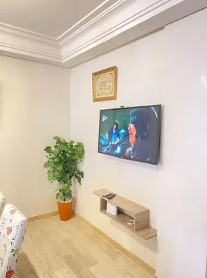 a living room with a tv on a wall at Apartment Comfortable Marrakech in Marrakech