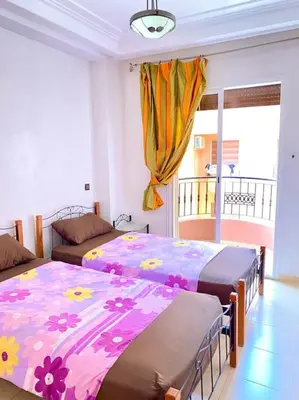 a bedroom with two beds and a balcony at Apartment Comfortable Marrakech in Marrakech