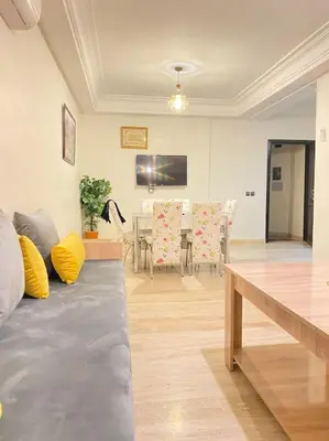 a living room with a couch and a dining room at Apartment Comfortable Marrakech in Marrakech