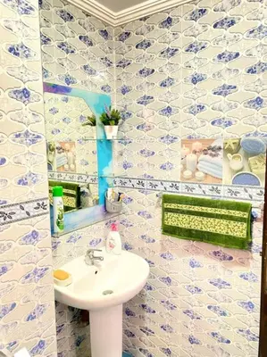 a bathroom with blue and white tiled walls and a sink at Apartment Comfortable Marrakech in Marrakech