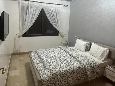 a bedroom with a large bed with a window at Marrakech Residence in Marrakech