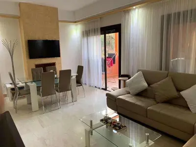 a living room with a couch and a table at Marrakech Residence in Marrakech