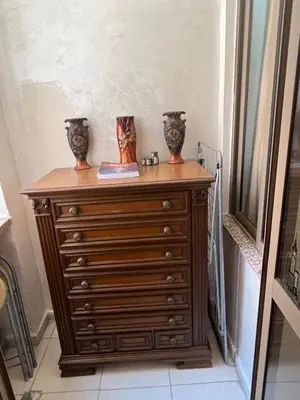 a wooden dresser with two vases on top of it at Appartement moderne a guéliz in Marrakech