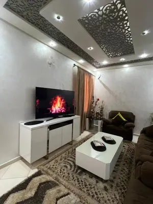 a living room with a flat screen tv on a wall at Appartement moderne a guéliz in Marrakech