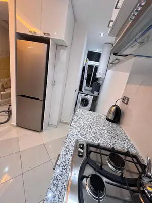 a kitchen with a stove and a counter top at Appartement Rénové avec Style et Parking surveillé in Marrakech