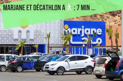 a group of cars parked in a parking lot at Appartement Rénové avec Style et Parking surveillé in Marrakech