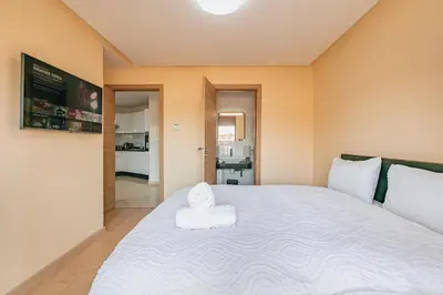 a bedroom with a large bed with a towel on it at Migdal Gueliz Apart Hôtel in Marrakech