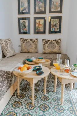 a living room with two tables with fruit on them at Boutique Hotel La Maison dArts et Medicine in Marrakech