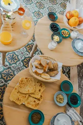 a table topped with two tables with plates of food at Boutique Hotel La Maison dArts et Medicine in Marrakech