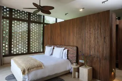 a bedroom with a large bed with a wooden wall at Villa Saman in Marrakech