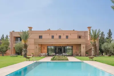 a house with a swimming pool in front of it at Villa Tamari in Marrakech
