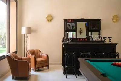 a bar with a pool table and chairs at Villa Tamari in Marrakech