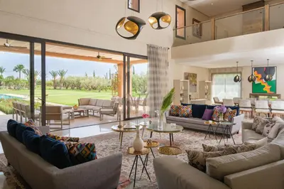 an open living room with couches and tables at Villa Tamari in Marrakech