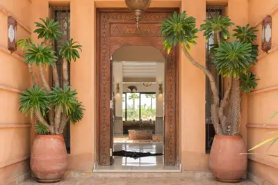 a hallway with a mirror and two palm trees at Villa Tamari in Marrakech