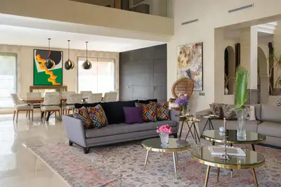 a living room with a couch and tables at Villa Tamari in Marrakech