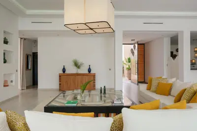 a living room with a glass table and a couch at Villa Netumia in Marrakech
