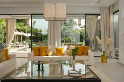 a living room with couches and a glass table at Villa Netumia in Marrakech