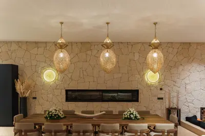 a dining room with a table and lights at Villa Eyline Amelkis Golf in Marrakech