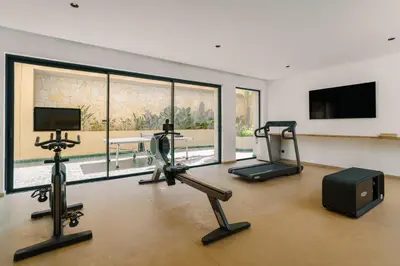 a gym with exercise equipment and a large window at Villa Eyline Amelkis Golf in Marrakech