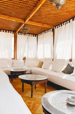 a living room with a couch and two tables at Boutique Hotel Riad Almoulouk in Marrakech