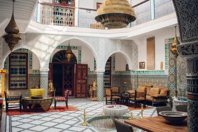a living room with a large room with tables and chairs at Boutique Hotel Riad Almoulouk in Marrakech