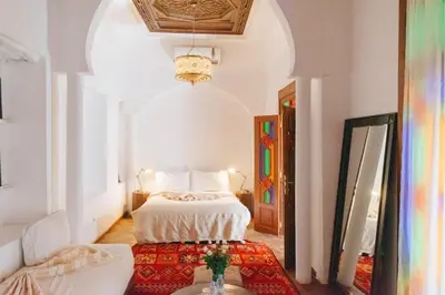 a bedroom with a bed and a table in a room at Boutique Hotel Riad Almoulouk in Marrakech