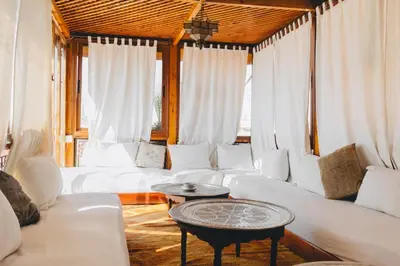 a living room with white couches and a table at Boutique Hotel Riad Almoulouk in Marrakech