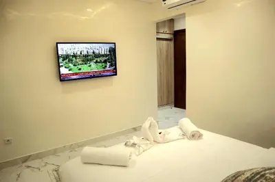 a hotel room with a tv on the wall at The Elite suites in Marrakech