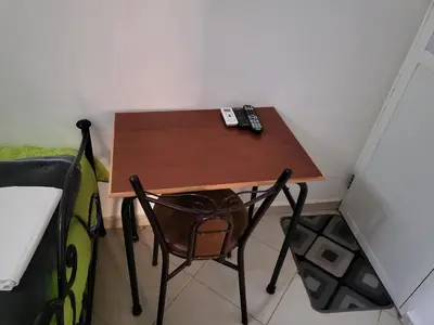 a small desk in a room with a bed and a chair at Maison D'hôte Dar ALBIDAWI in Marrakech