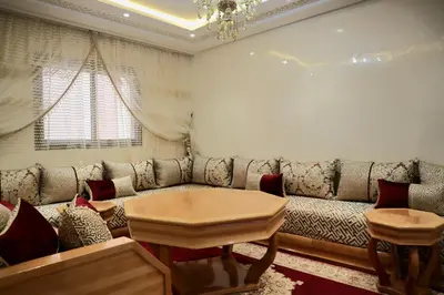a living room with a couch and a table at Majestic luxe appartment in Marrakech