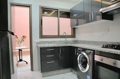 a kitchen with a washer and a washing machine at Majestic luxe appartment in Marrakech