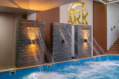 a swimming pool in a hotel room with a water feature at Kasbel 2 Appart & Pool in Marrakech