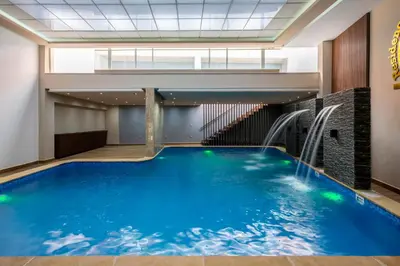 a swimming pool in a building with a water slide at Kasbel 2 Appart & Pool in Marrakech