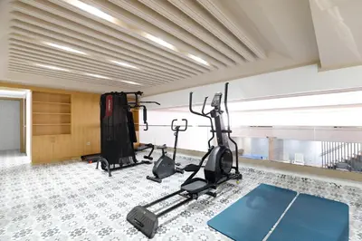 a gym with treadmills and exercise bikes in a room at Kasbel 2 Appart & Pool in Marrakech
