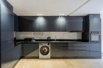 a kitchen with a washing machine and a sink at Kasbel 2 Appart & Pool in Marrakech
