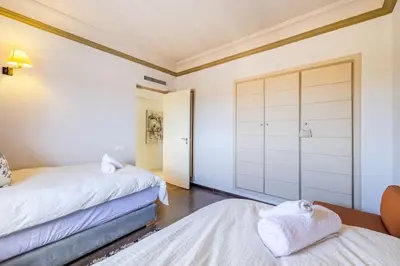 a bedroom with two beds and a closet at Best location new appart hivernag Pool FreeParking in Marrakech