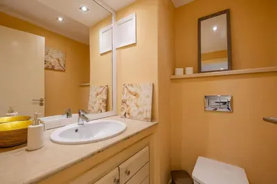 a bathroom with a sink and a mirror at Best location new appart hivernag Pool FreeParking in Marrakech