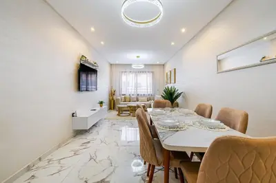 a dining room with a table and chairs at Family appartment Palmeraie Gate with pool in Marrakech