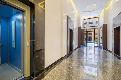 a hallway of a building with blue walls and floors at Family appartment Palmeraie Gate with pool in Marrakech