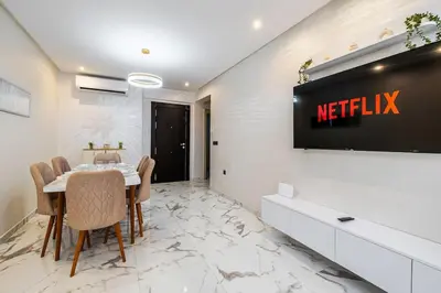 a meeting room with a table and a television on a wall at Family appartment Palmeraie Gate with pool in Marrakech