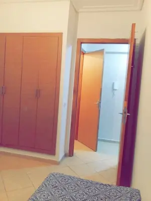 a room with two sliding doors and a mirror at Appartement calme et spacieux in Marrakech