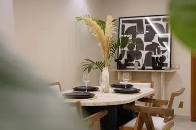 a dining room table with plates and glasses on it at Beldi Chic apartment in Marrakech in Marrakech