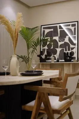 a dining room table with two glasses and a vase at Beldi Chic apartment in Marrakech in Marrakech